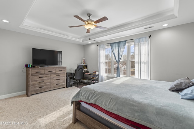 carpeted bedroom with ceiling fan, ornamental molding, and a raised ceiling