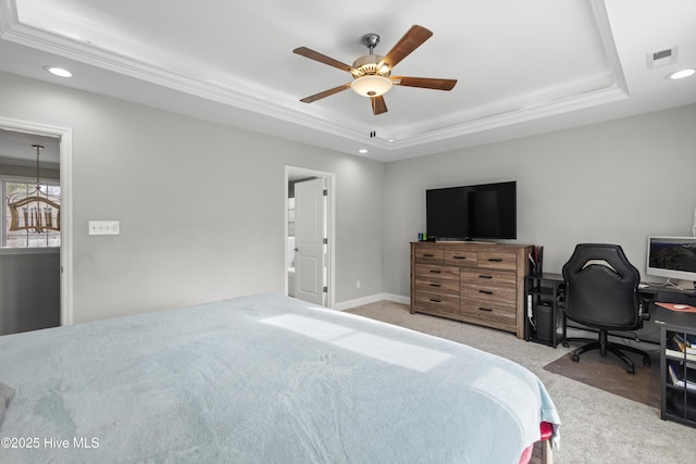 bedroom featuring light carpet, crown molding, a raised ceiling, and ceiling fan