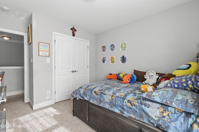 bedroom featuring light carpet and a closet