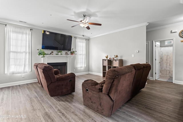 living room with crown molding, hardwood / wood-style floors, and ceiling fan