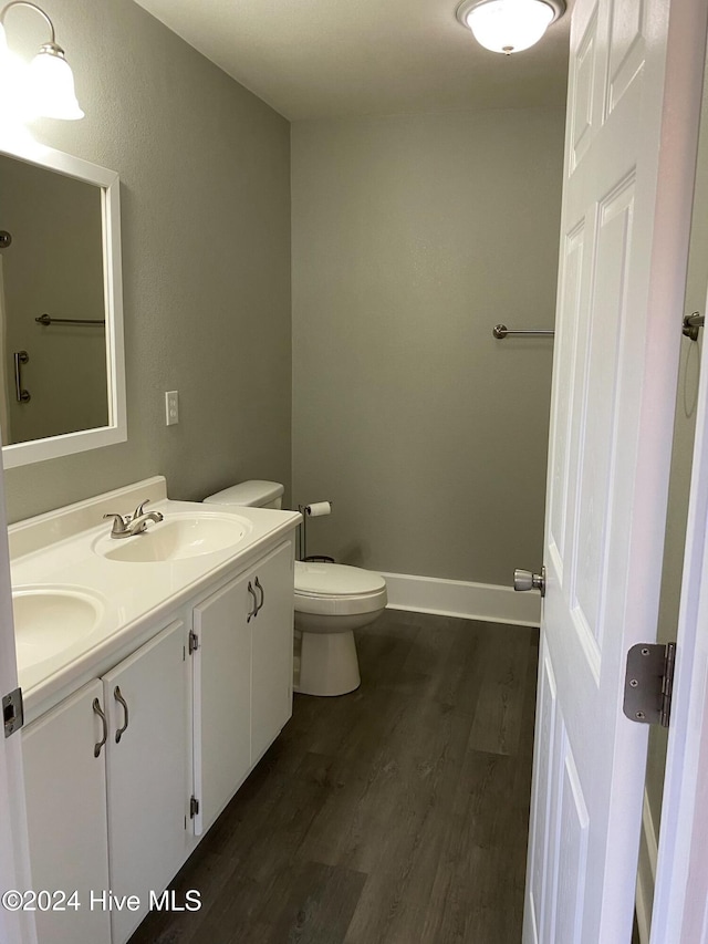 bathroom featuring vanity, wood-type flooring, and toilet