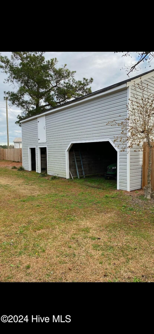 view of outbuilding with a yard