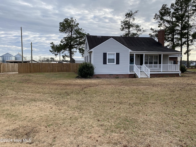 view of front of property featuring covered porch and a front yard