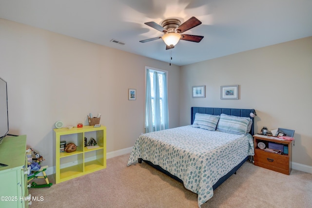 bedroom featuring light colored carpet and ceiling fan