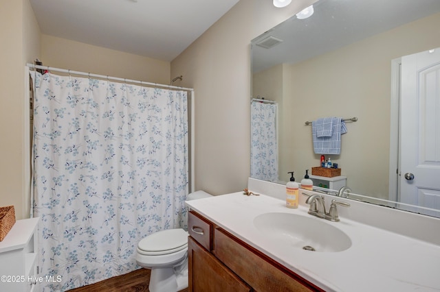 bathroom featuring a shower with curtain, hardwood / wood-style floors, vanity, and toilet