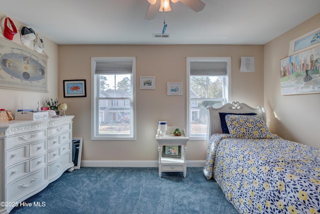 carpeted bedroom featuring multiple windows and ceiling fan