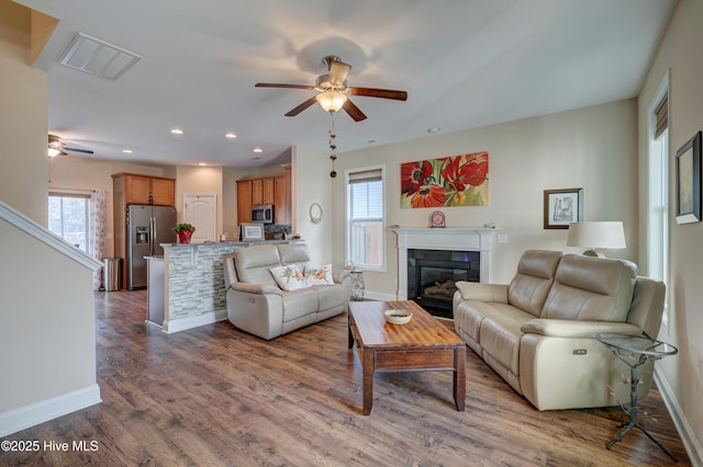 living room with ceiling fan and hardwood / wood-style flooring