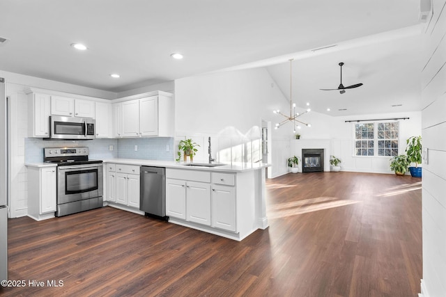 kitchen with white cabinets, sink, kitchen peninsula, and stainless steel appliances