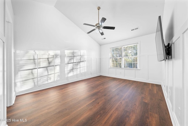 unfurnished living room with ceiling fan, dark wood-type flooring, and vaulted ceiling