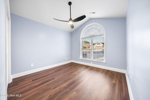 spare room featuring ceiling fan, lofted ceiling, and dark wood-type flooring