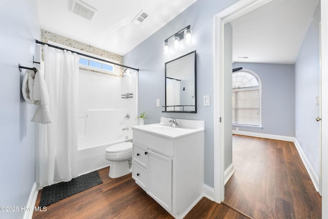 full bathroom with shower / bath combo with shower curtain, vanity, hardwood / wood-style floors, and toilet