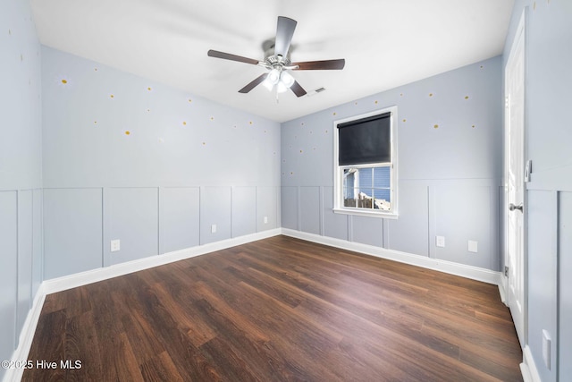 unfurnished room with ceiling fan and dark wood-type flooring