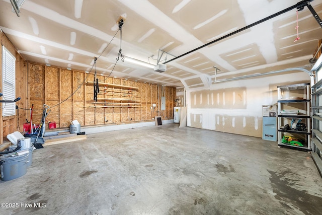 garage with electric panel, electric water heater, and a garage door opener