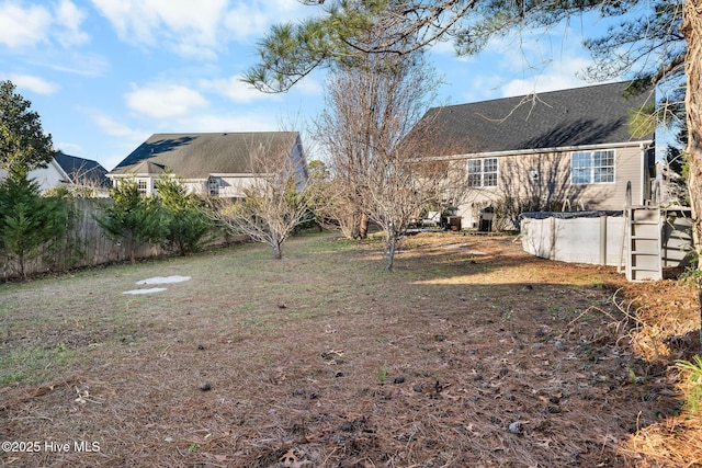 view of yard with a covered pool