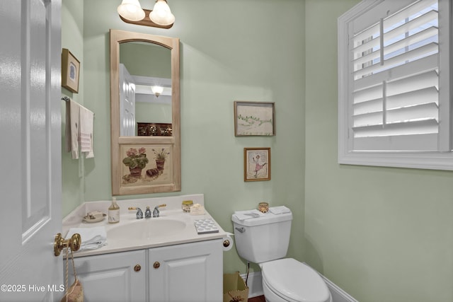 bathroom with vanity, toilet, and plenty of natural light