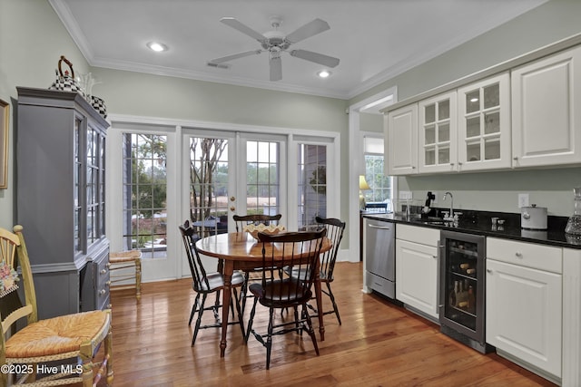 kitchen featuring white cabinetry, dishwasher, sink, beverage cooler, and french doors