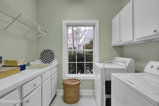 laundry room with separate washer and dryer, sink, cabinets, and light tile patterned flooring