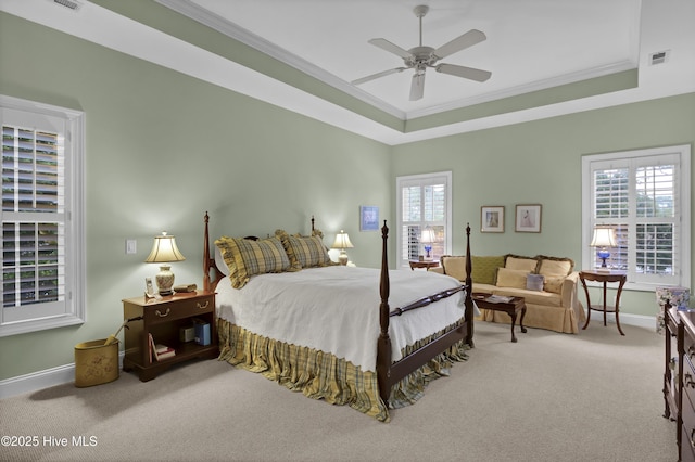 bedroom featuring crown molding, carpet floors, ceiling fan, and a tray ceiling