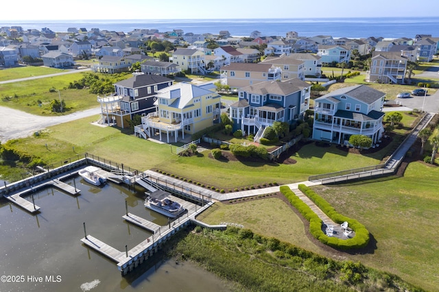 drone / aerial view with a residential view and a water view