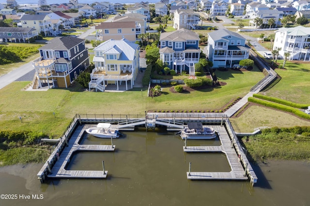 birds eye view of property with a residential view and a water view