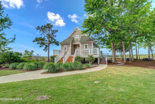 view of front facade with stairs, a front lawn, and a deck