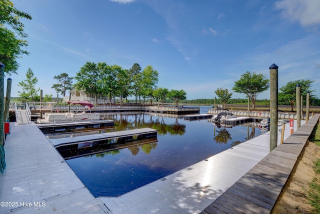 view of pool with a water view and a dock