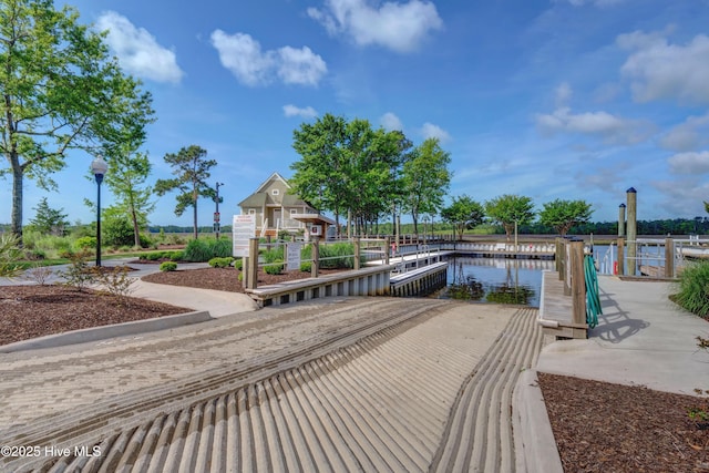 view of community featuring a water view and a dock
