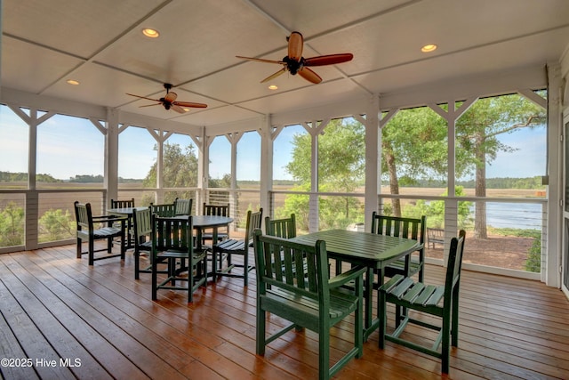 sunroom / solarium with a water view, a wealth of natural light, and ceiling fan