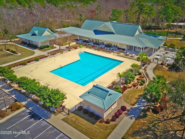 pool with a patio and fence