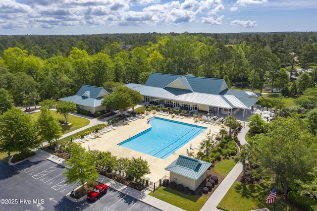 drone / aerial view featuring a wooded view