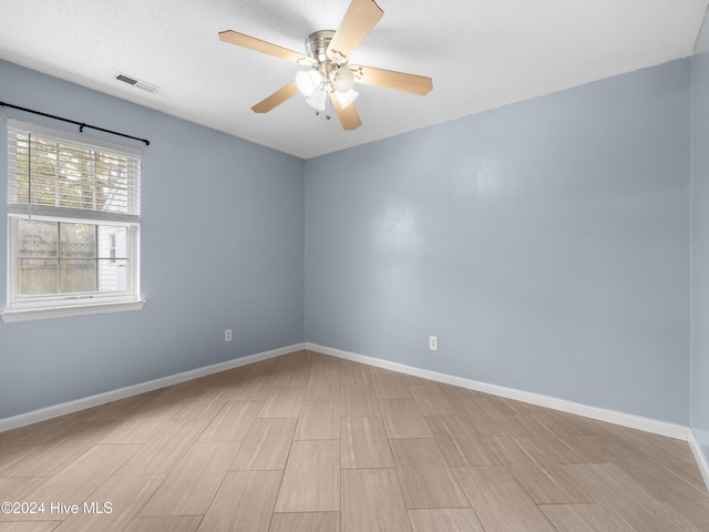 unfurnished room with ceiling fan