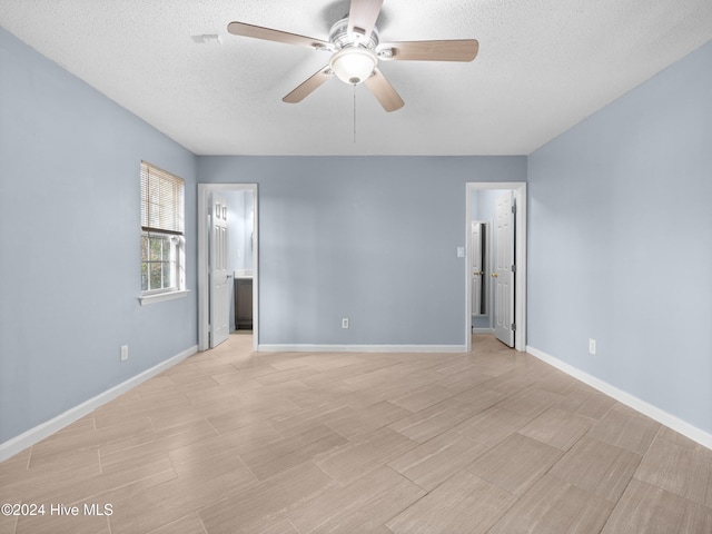 unfurnished room featuring ceiling fan and a textured ceiling