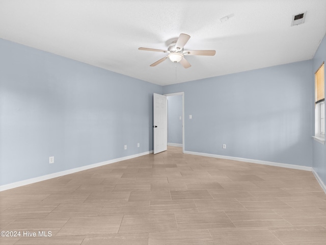 unfurnished room with ceiling fan