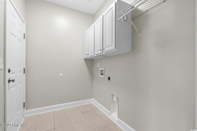 clothes washing area featuring hookup for an electric dryer, cabinets, light tile patterned floors, and hookup for a washing machine