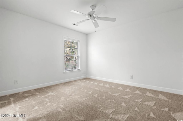 empty room with ceiling fan and carpet floors