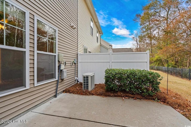 view of property exterior featuring central AC unit and a patio area