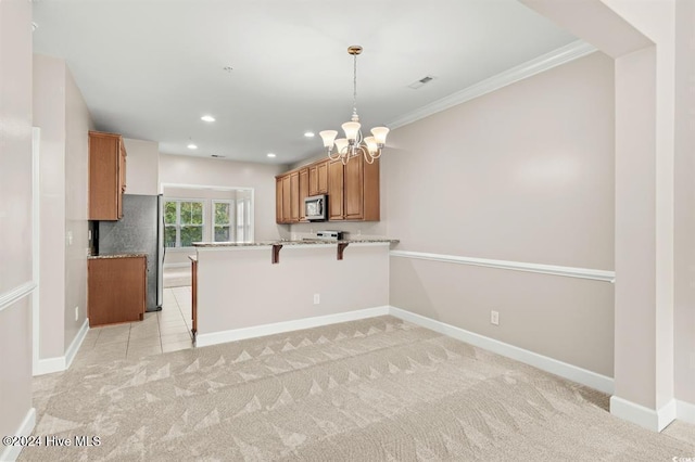 kitchen featuring kitchen peninsula, appliances with stainless steel finishes, a breakfast bar, light colored carpet, and a notable chandelier