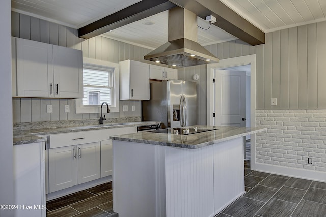 kitchen featuring island exhaust hood, white cabinets, black appliances, beamed ceiling, and a center island