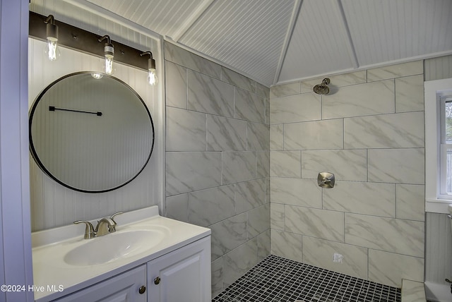 bathroom featuring tiled shower and vanity