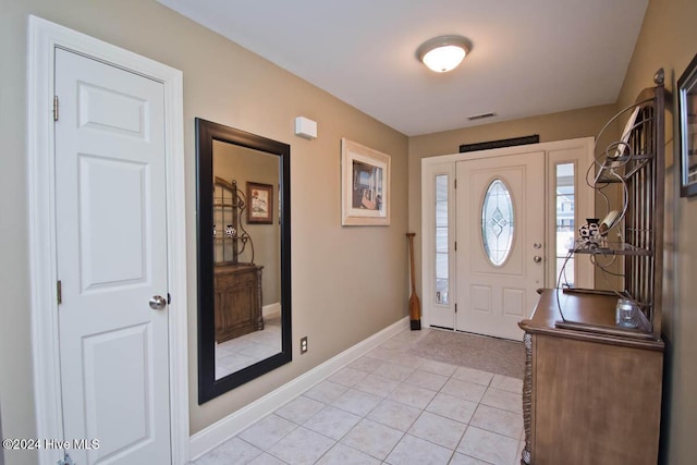 entryway with light tile patterned floors