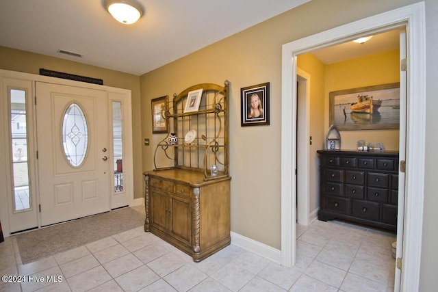 foyer featuring light tile patterned flooring