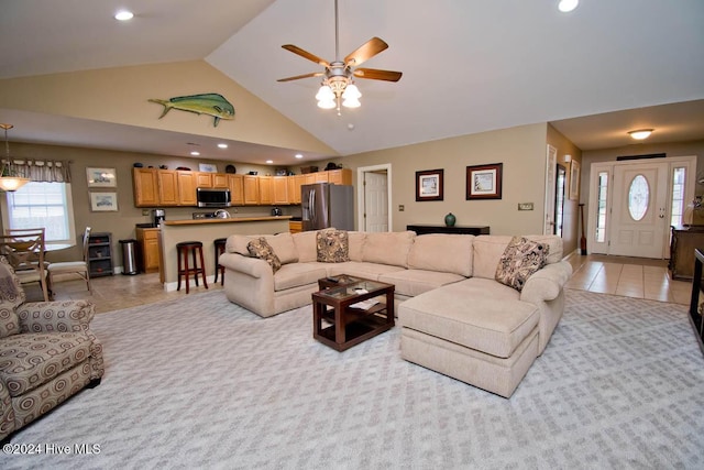 living room with ceiling fan, light tile patterned floors, and high vaulted ceiling