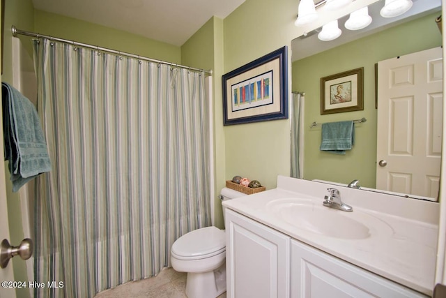 bathroom with tile patterned floors, vanity, and toilet