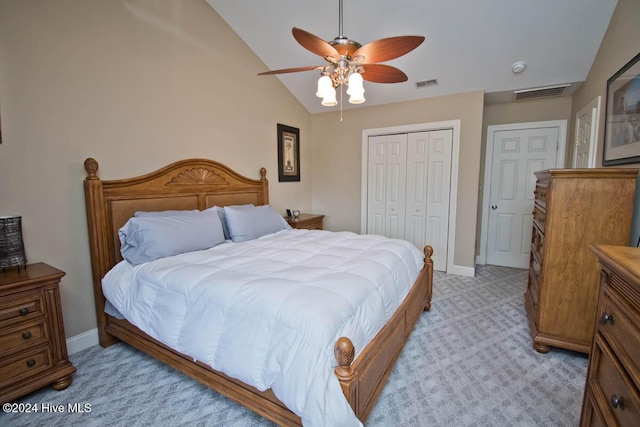 bedroom featuring ceiling fan, a closet, light colored carpet, and lofted ceiling