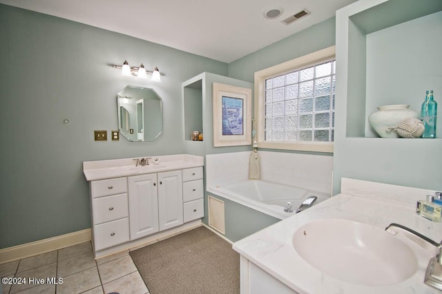 bathroom with tile patterned flooring, vanity, and a bathing tub