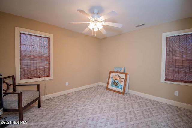 living area featuring ceiling fan and light carpet