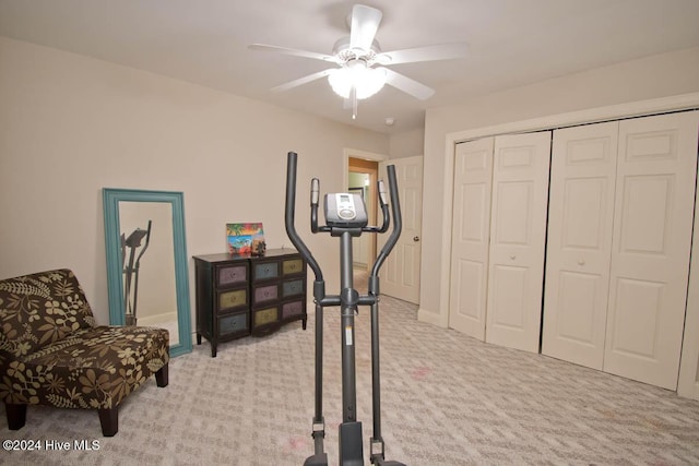 exercise area featuring light carpet and ceiling fan