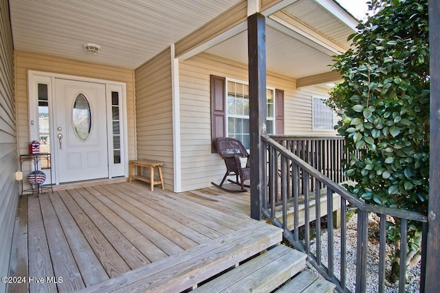 wooden terrace featuring covered porch