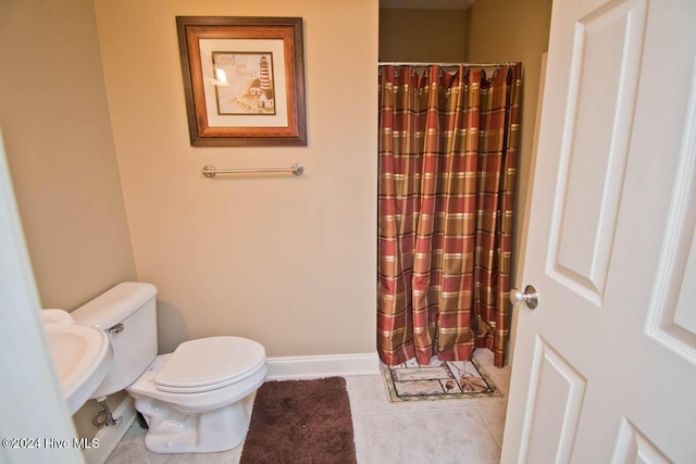 bathroom with tile patterned floors and toilet