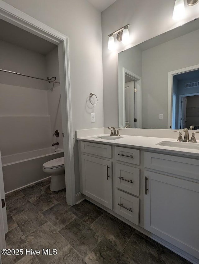 full bathroom featuring toilet, vanity, and  shower combination